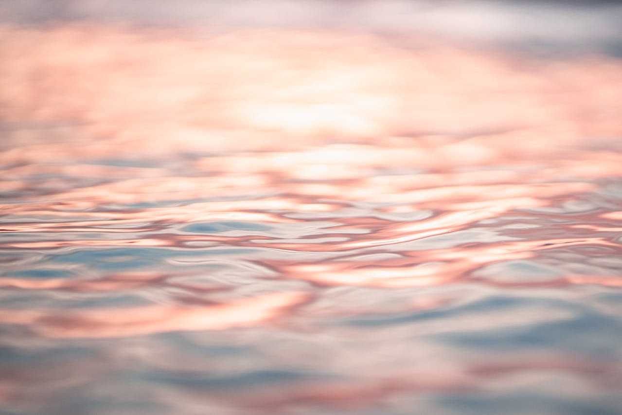 yellow-pink light reflecting on water