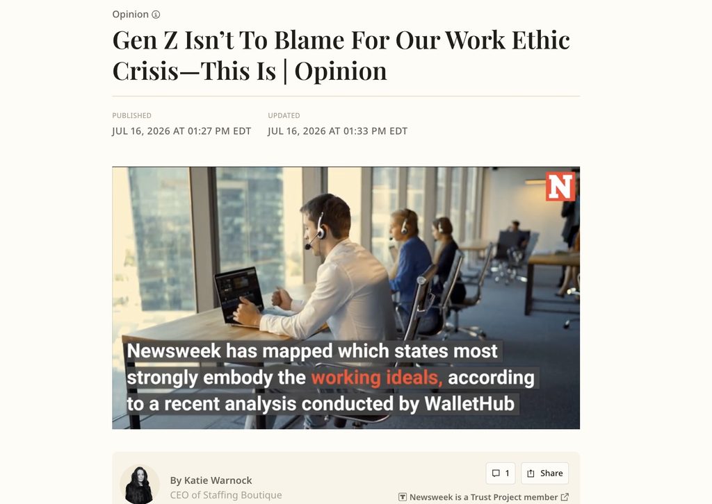 People working at desktops sitting at a desk and article on work ethic crisis.